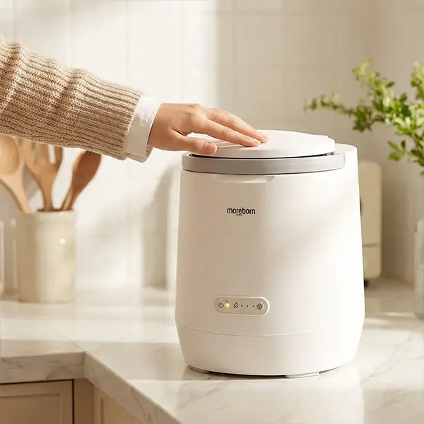 Close-up of Moreborn countertop composter showing its compact size and easy-to-use control panel.