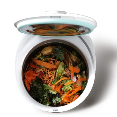 Initial view inside the Mb12 smart composter bucket filled with fresh food waste like vegetable peels and leftovers, before the 24-hour fermentation process begins.